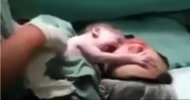 Newborn Baby Clings To Her Mother's Face Seconds After Being Born