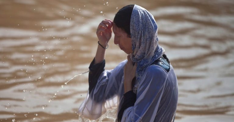 More than 20,000 Orthodox Christians Flock to Jordan River to Be Baptized