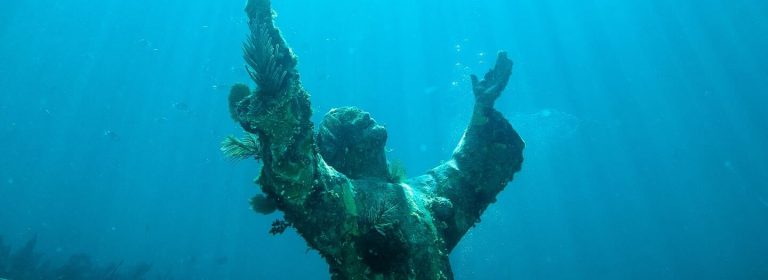 Sigmund Freud dangling by an arm and Jesus at the bottom of the sea: Strange sculptures and the urgency of faith today